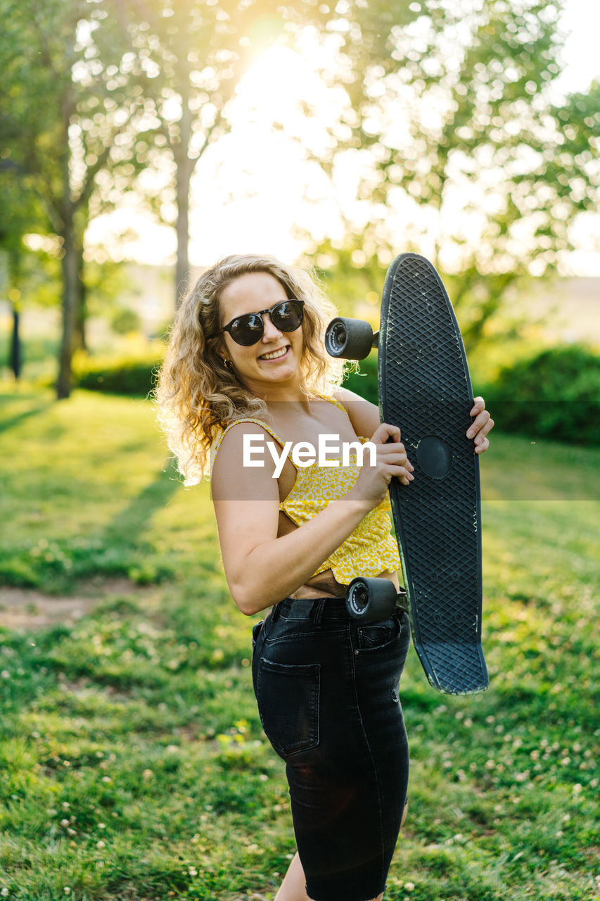 Young woman wearing sunglasses standing outdoors