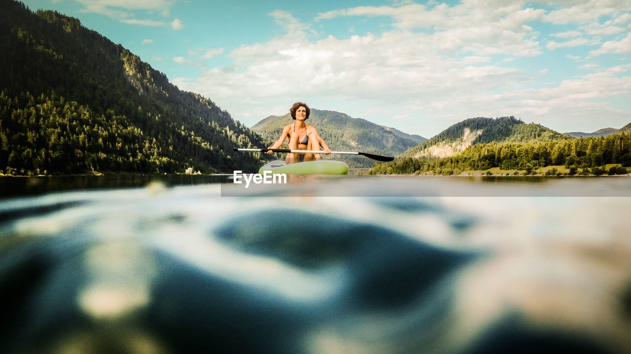 REFLECTION OF WOMAN IN LAKE