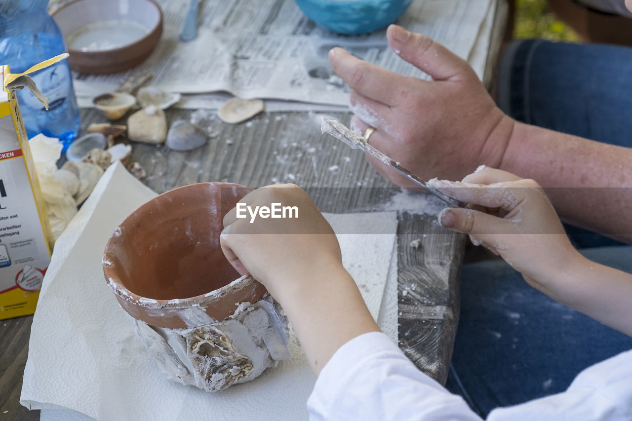 cropped hands of man preparing food at workshop