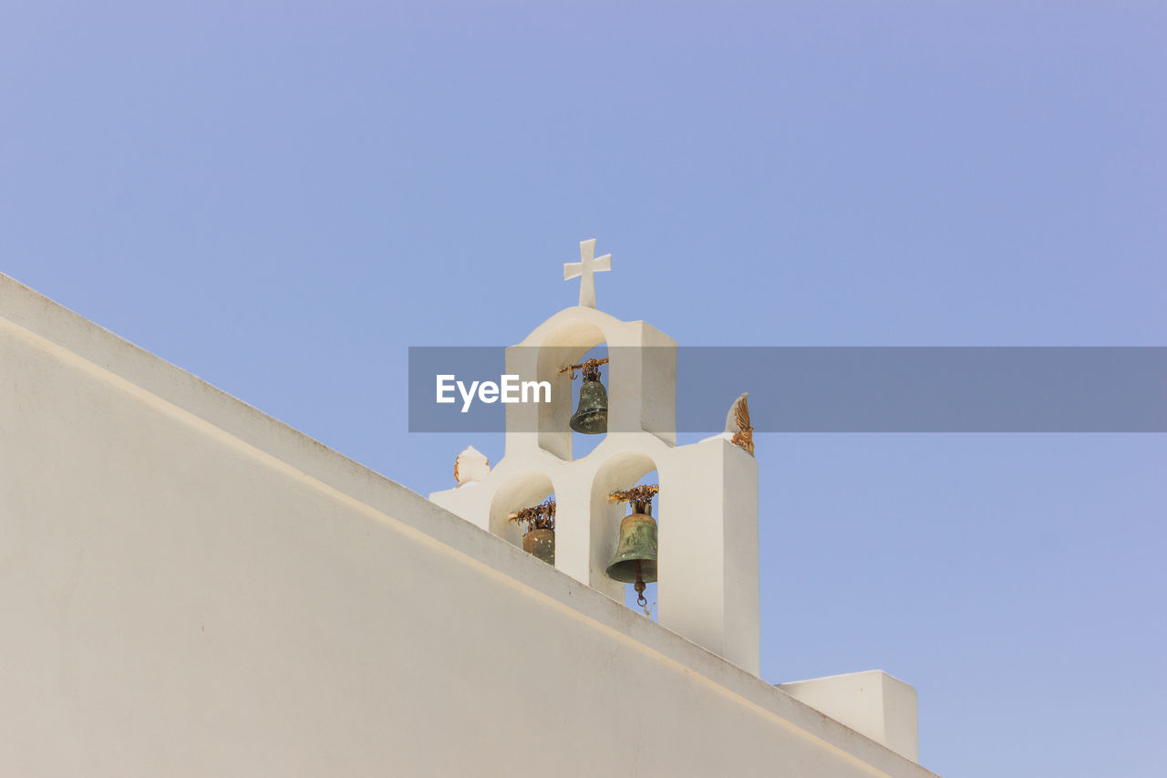 Low angle view of greek church against clear blue sky