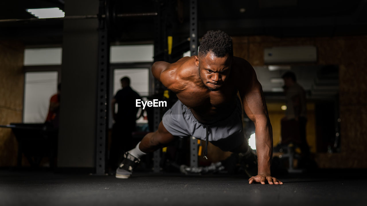 side view of man exercising in gym