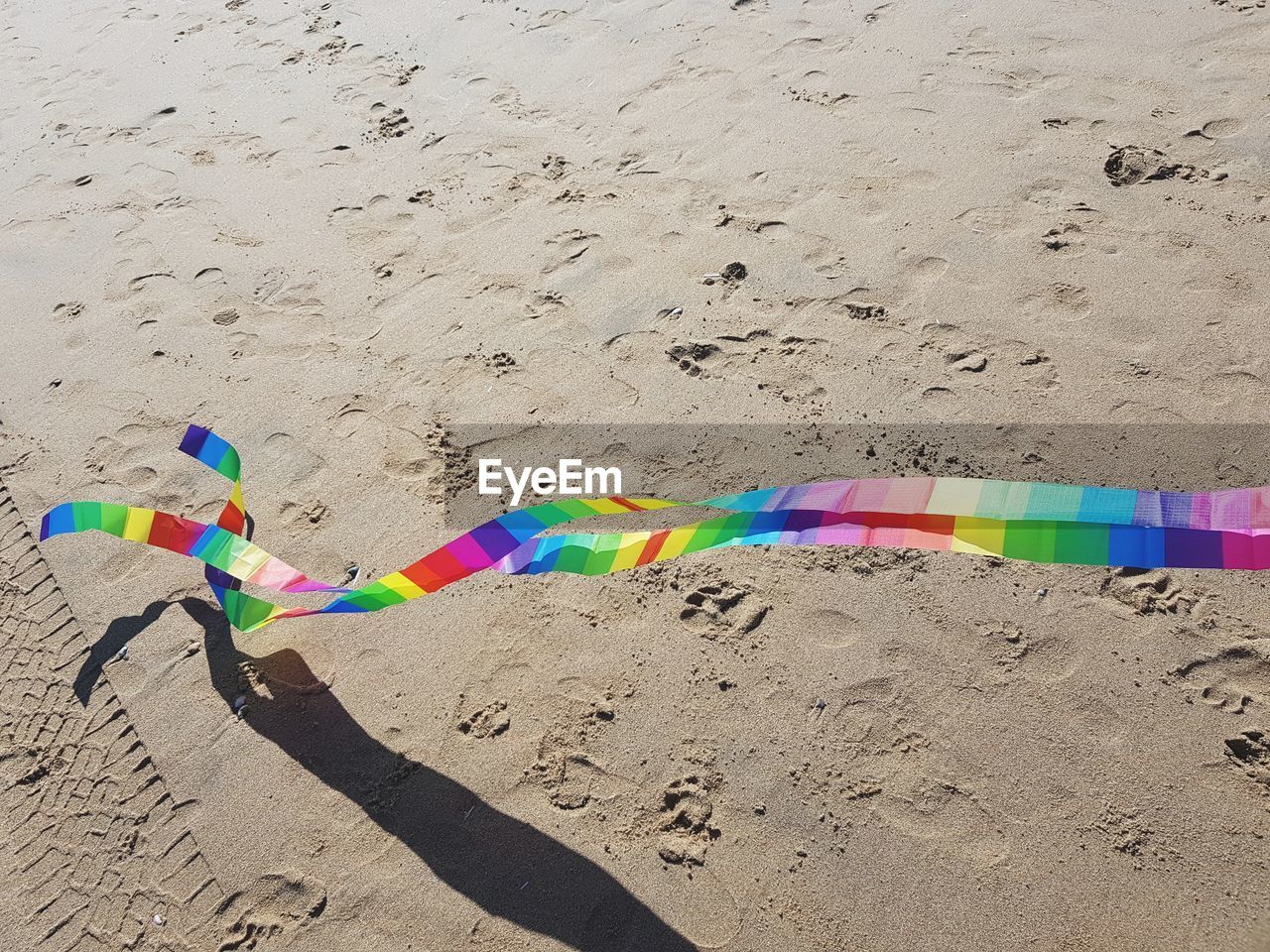 MULTI COLORED UMBRELLA ON SAND