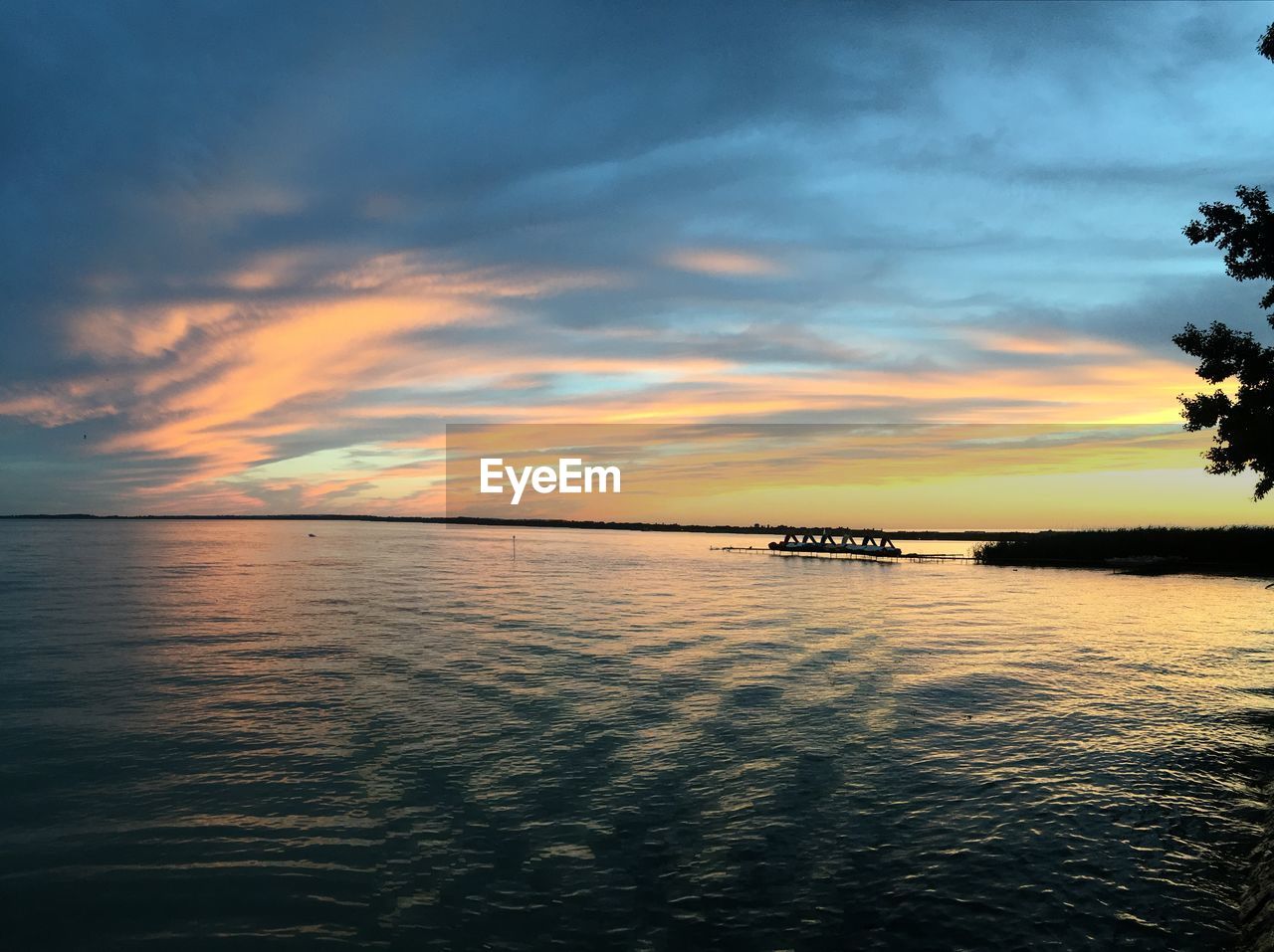 SCENIC VIEW OF SEA AT SUNSET