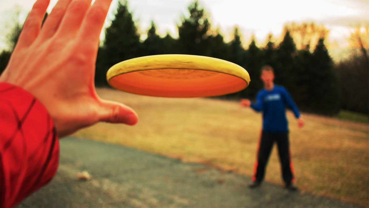 Close-up of hands playing outdoors