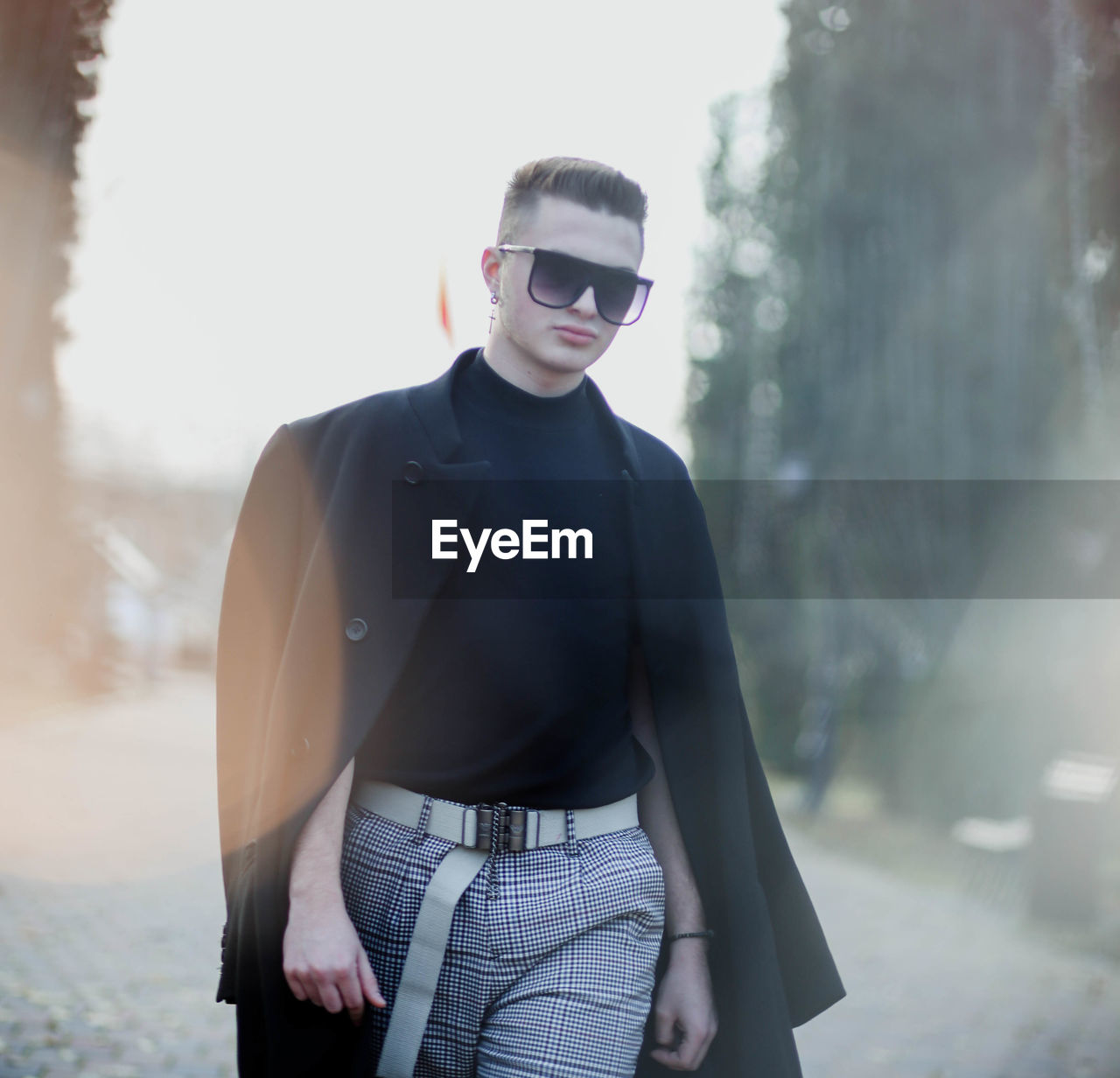 Portrait of young man wearing sunglasses standing outdoors