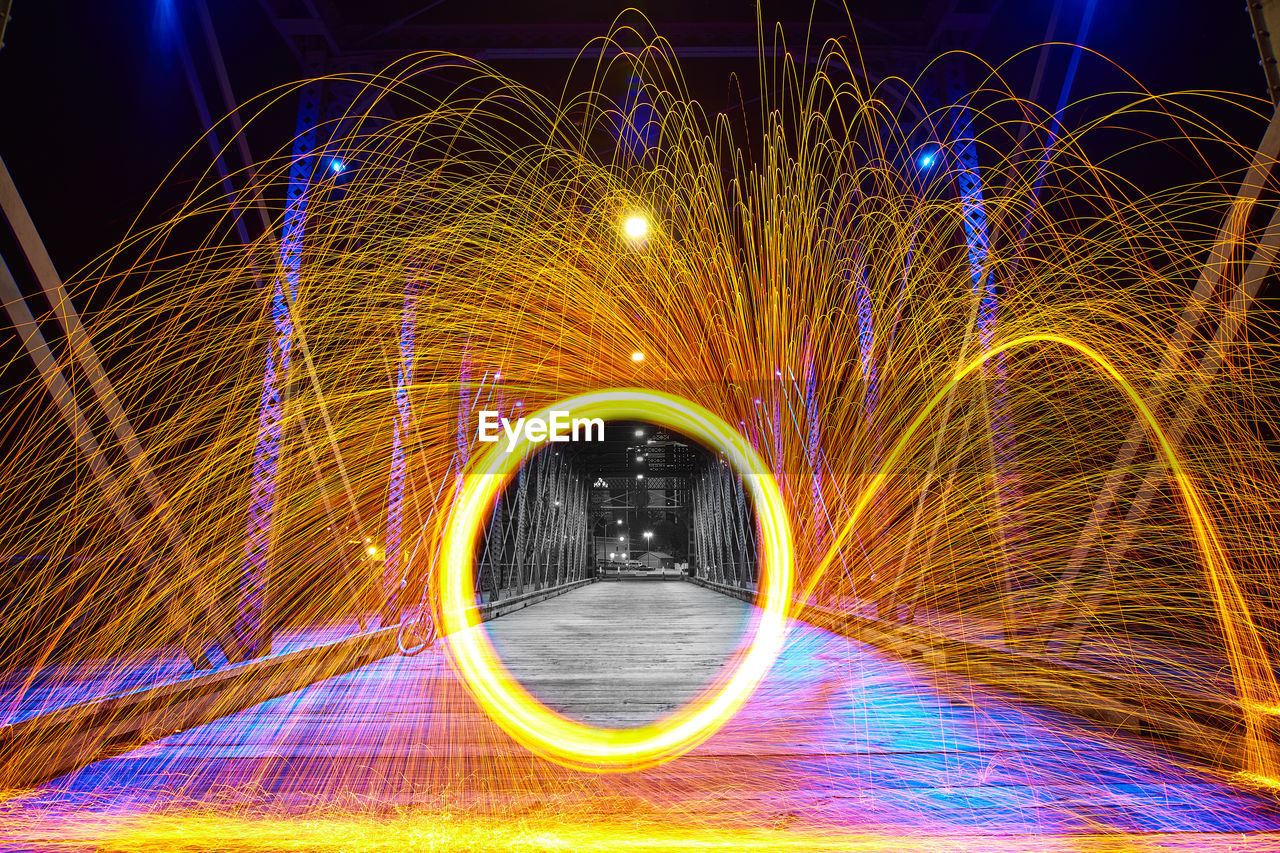 Steel wool orange sparks on wells street bridge in fort wayne, indiana