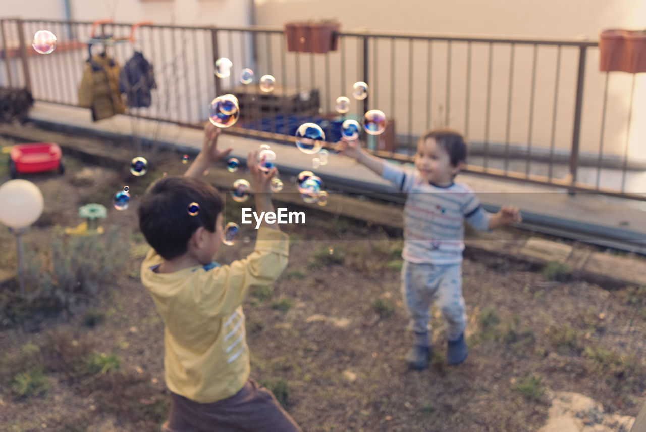 FULL LENGTH OF CHILDREN PLAYING IN A ROW