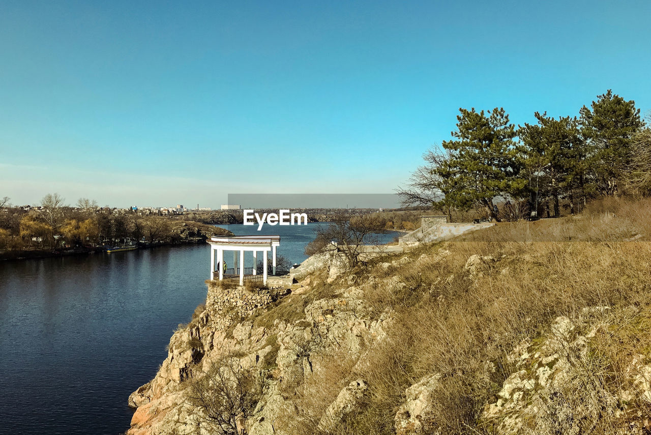 Scenic view of lake against clear blue sky