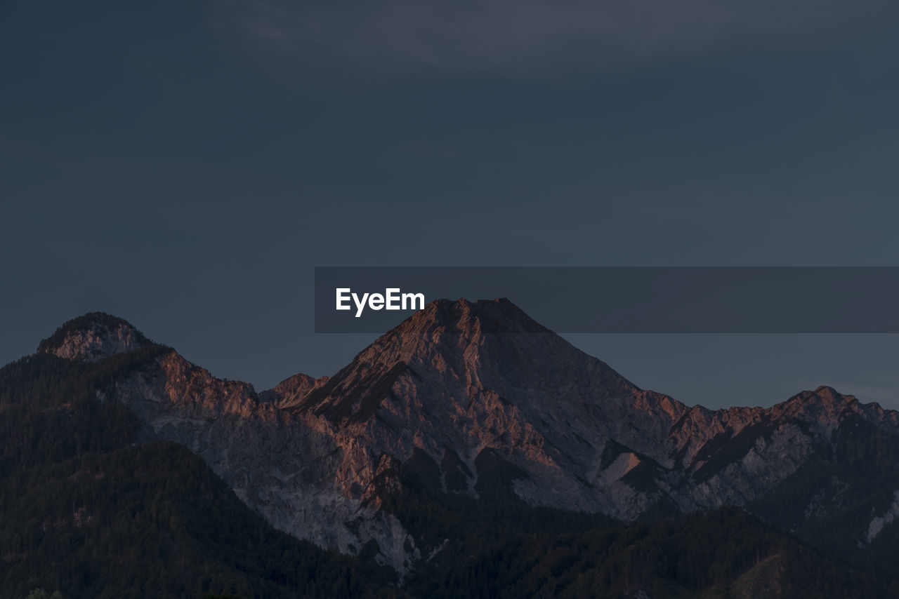 LOW ANGLE VIEW OF SNOWCAPPED MOUNTAINS AGAINST SKY