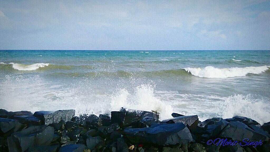 WAVES SPLASHING ON ROCKS