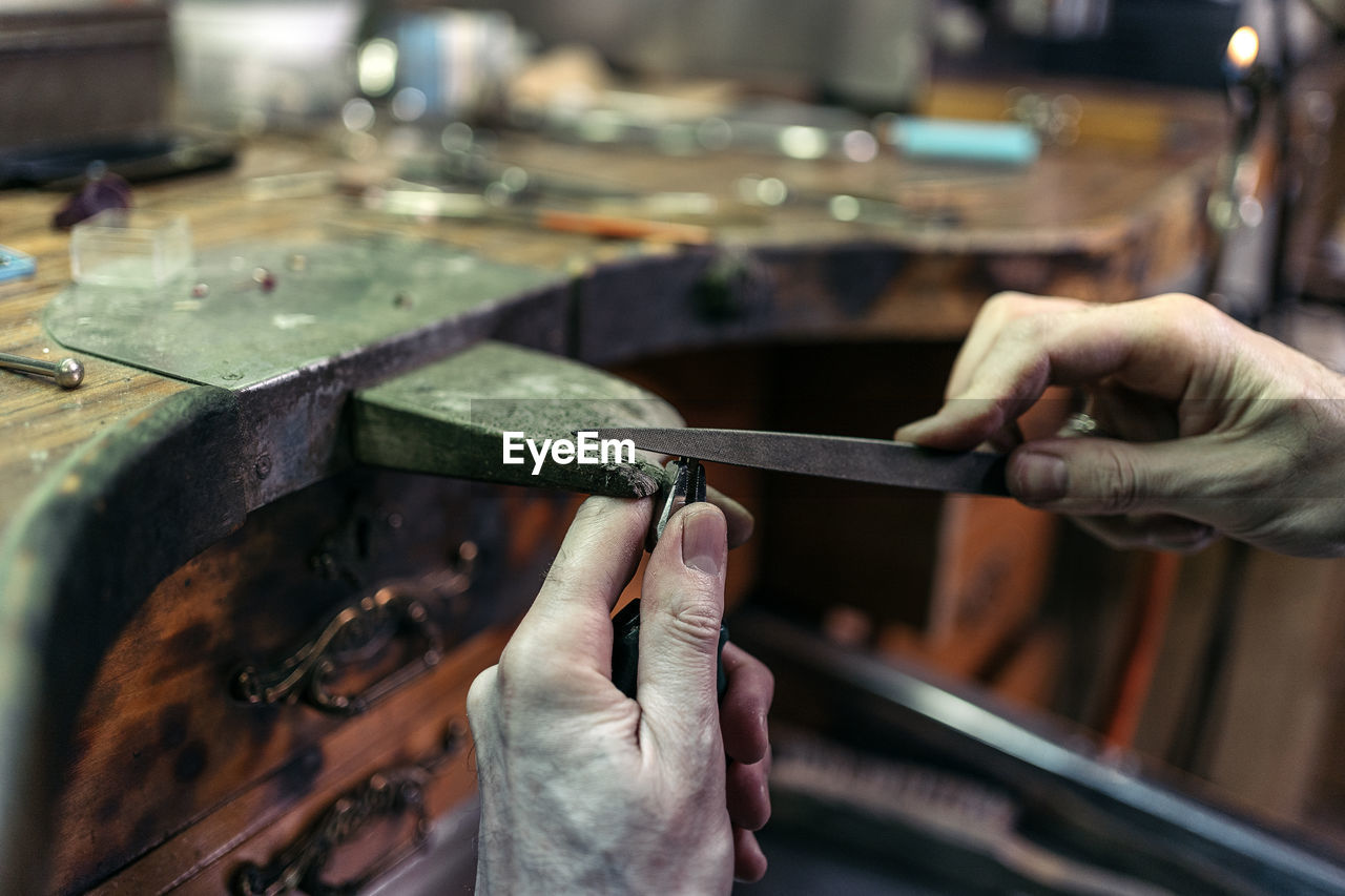 Midsection of man working in workshop