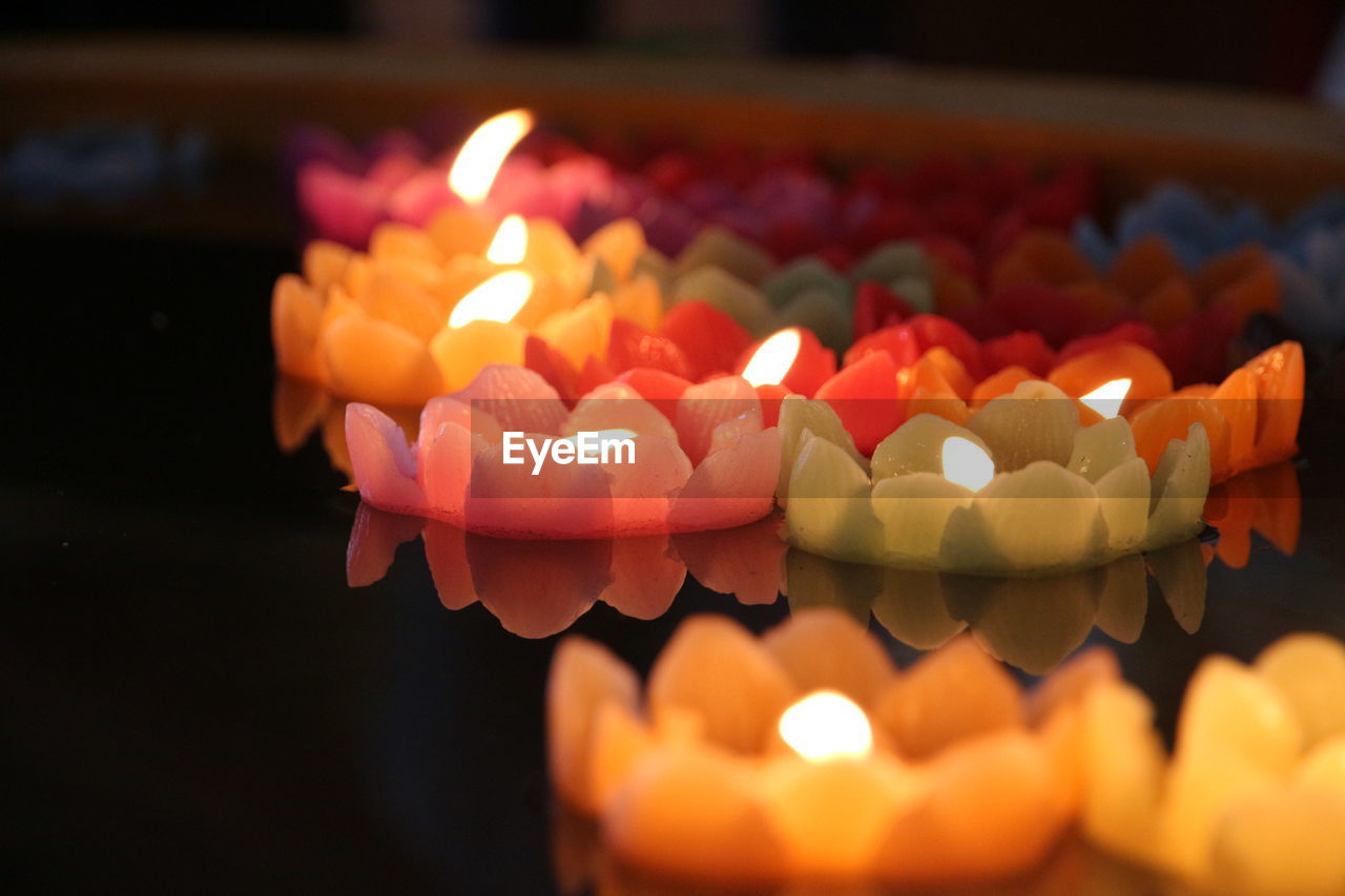 CLOSE-UP OF ILLUMINATED CAKE