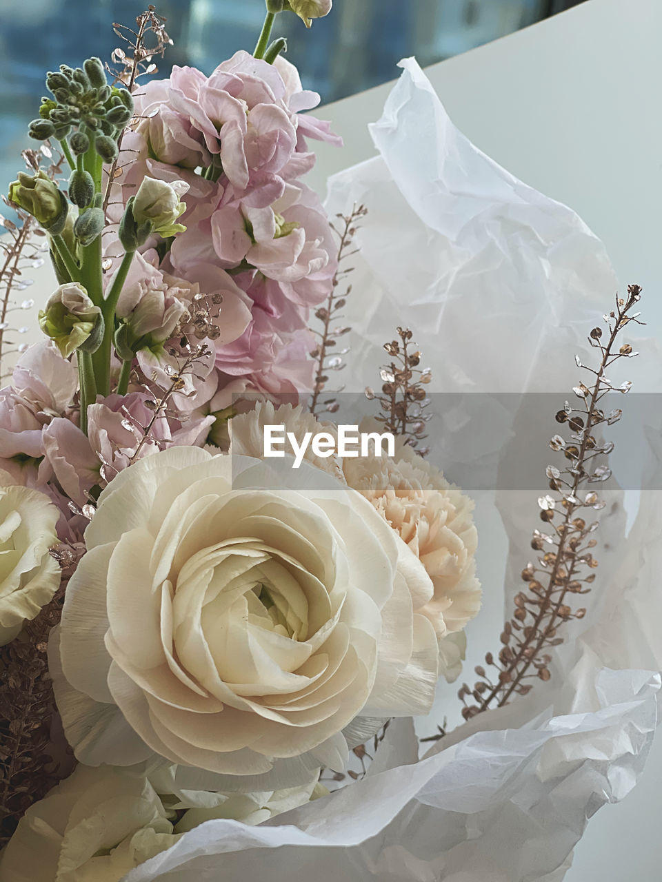 CLOSE-UP OF WHITE ROSE ON BOUQUET