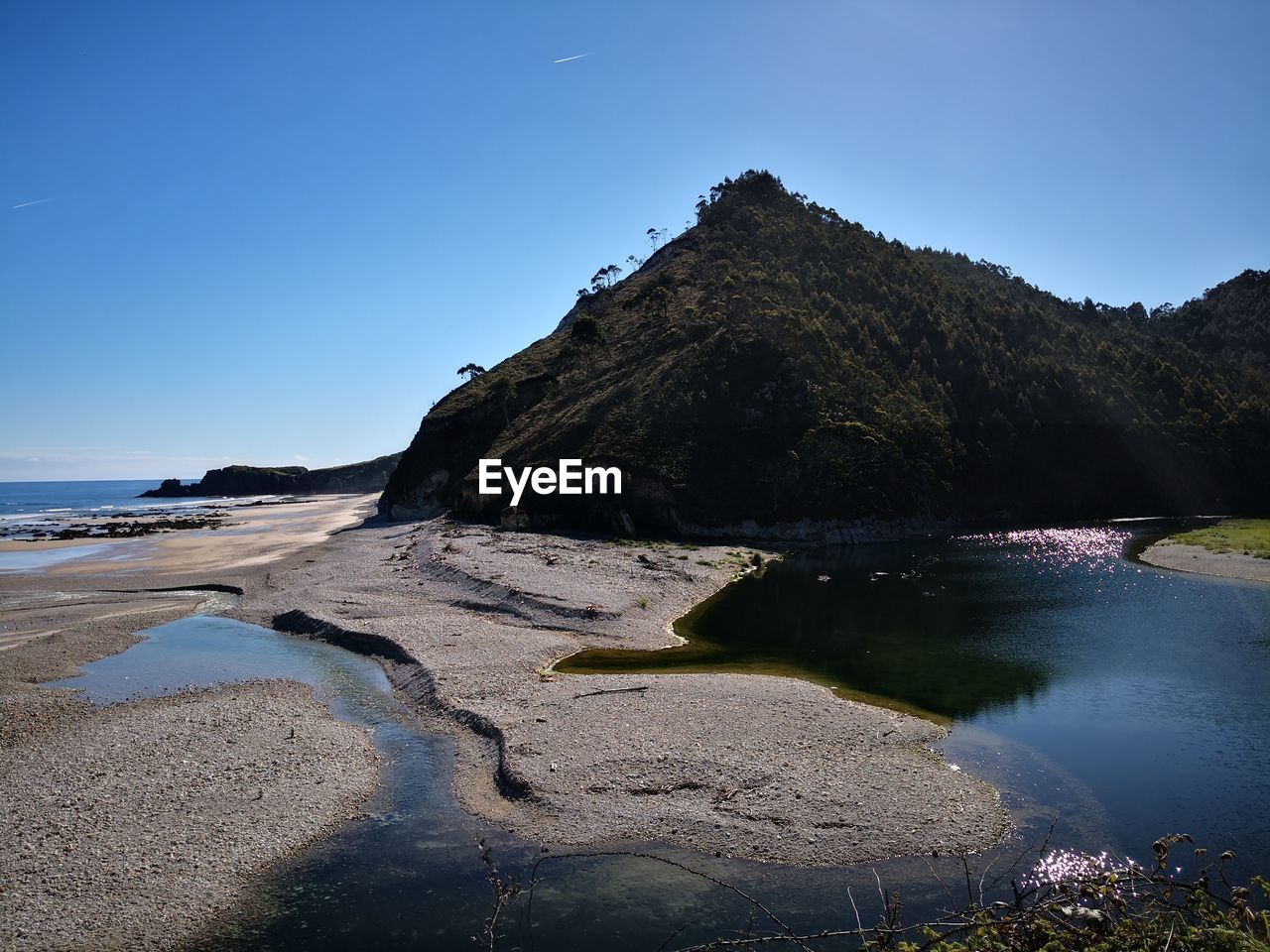 Scenic view of sea against clear blue sky