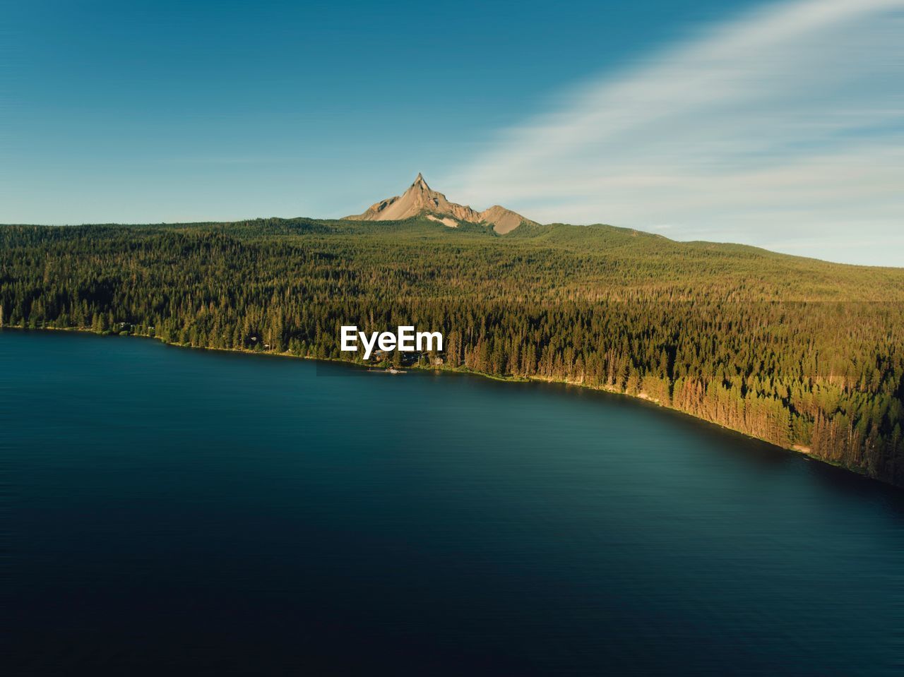 Scenic view of lake by mountain against sky