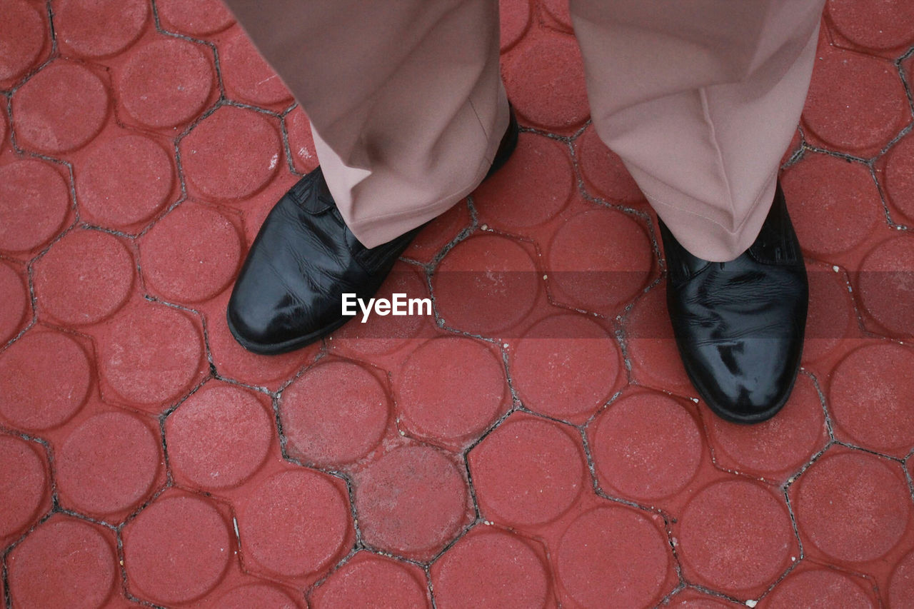 Overhead view of man standing on tiled floor