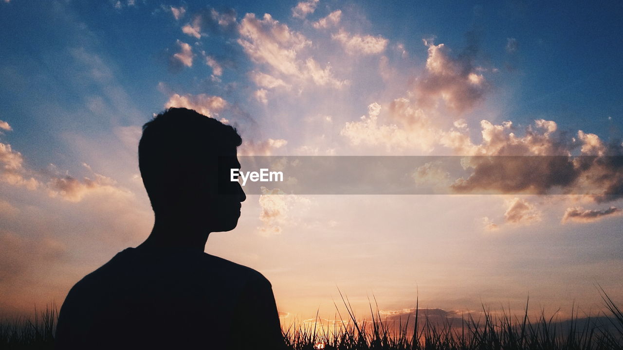 Silhouette of person standing in field
