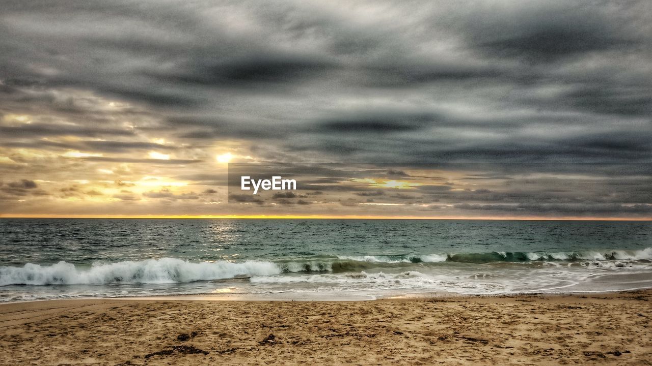 SCENIC VIEW OF SEA AGAINST STORM CLOUDS