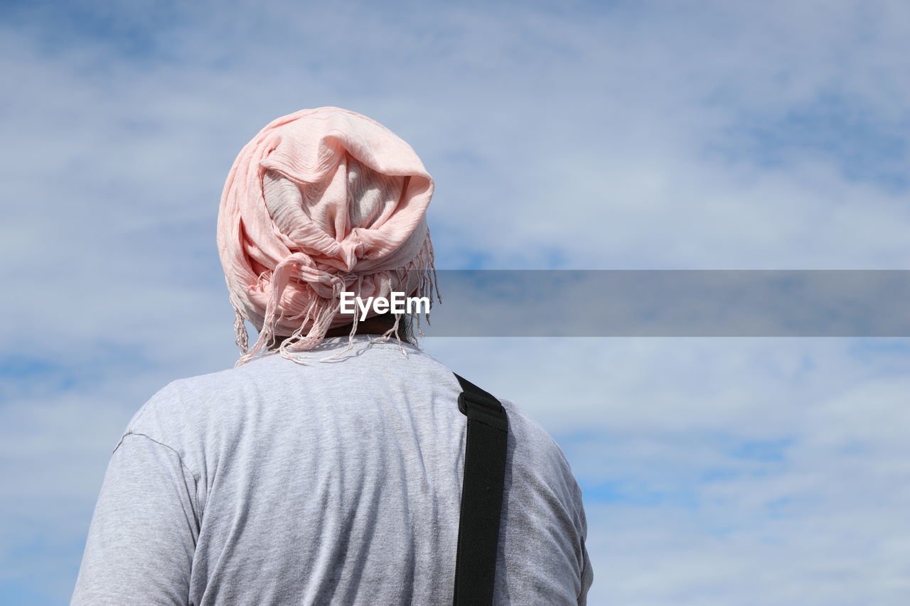 Rear view of man standing against sky