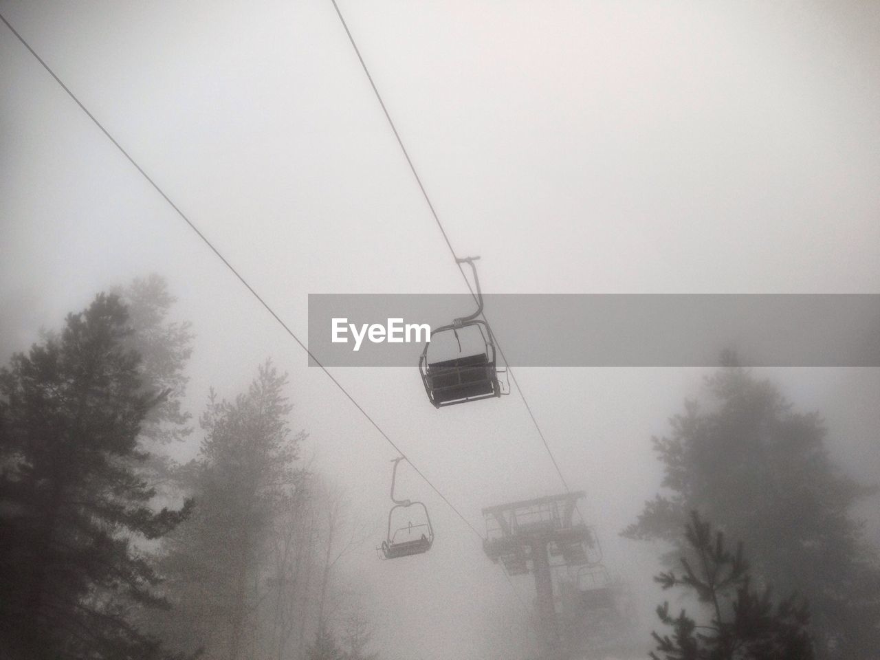 Gondola ride in fog against sky