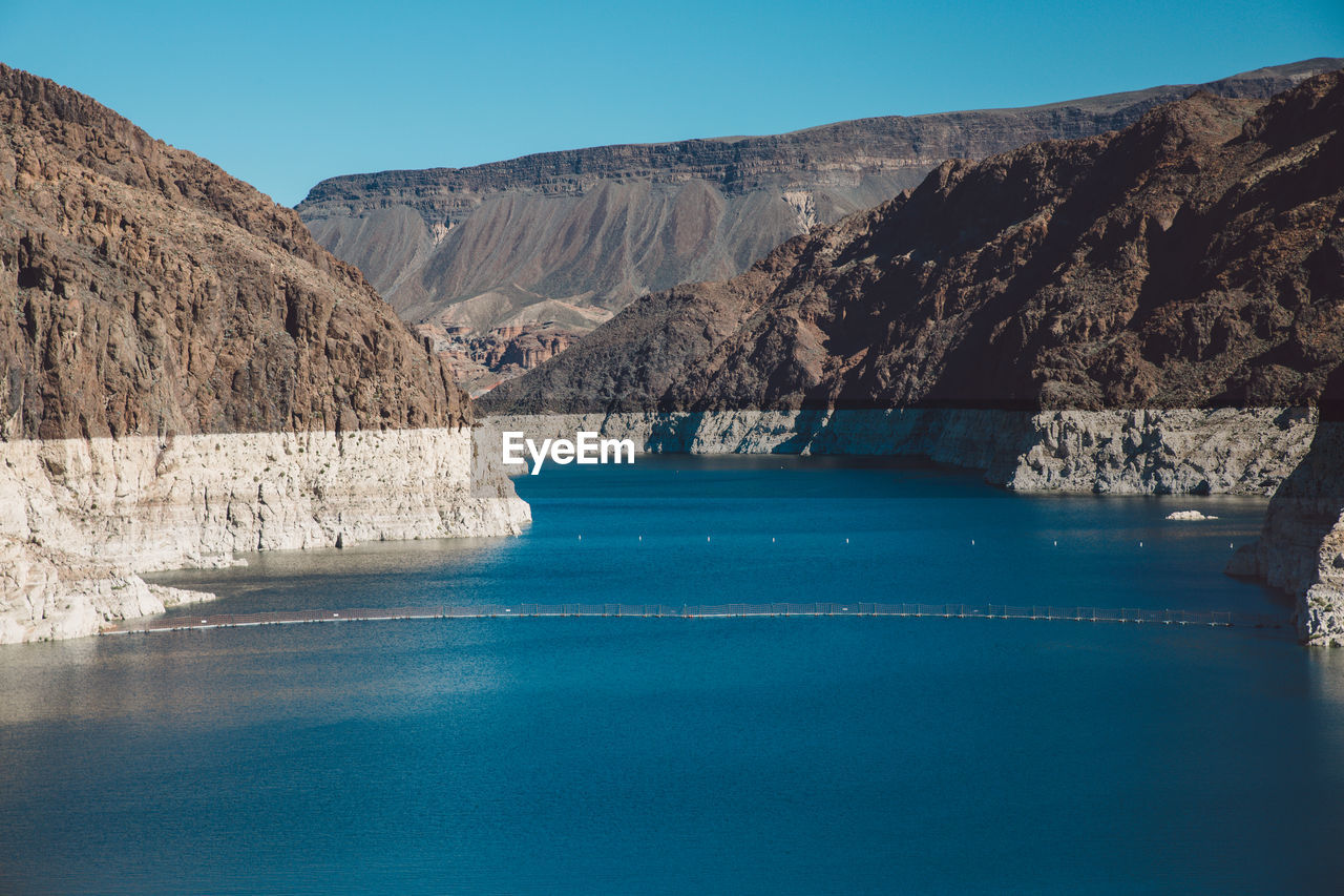 Scenic view of mountains against clear blue sky