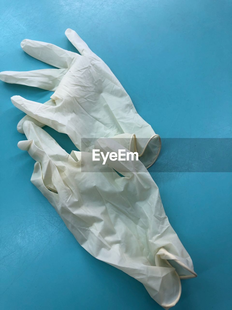Close-up of surgical gloves on blue background