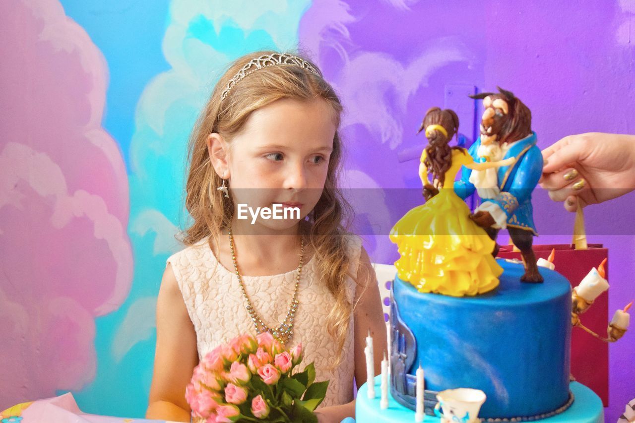 Girl looking at birthday cake