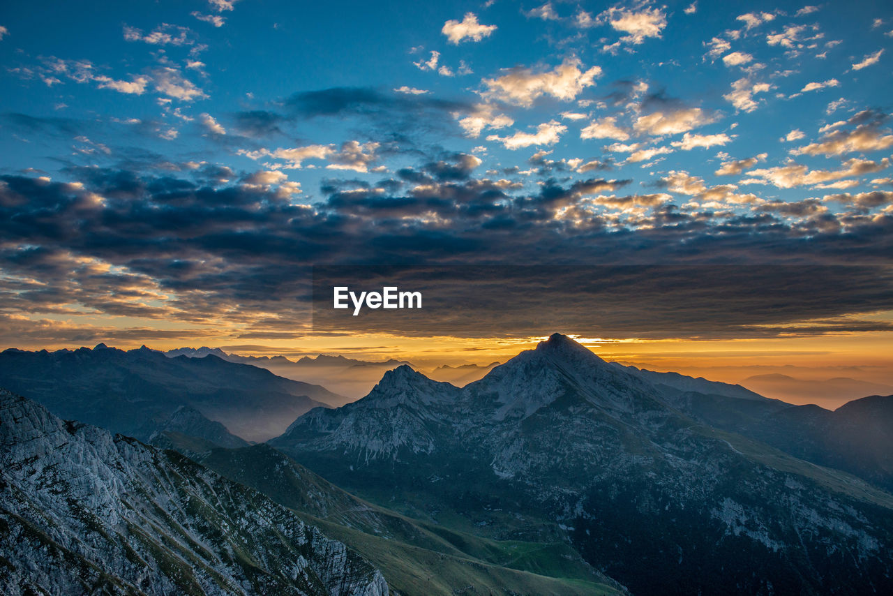 Scenic view of snowcapped mountains against sky during sunset