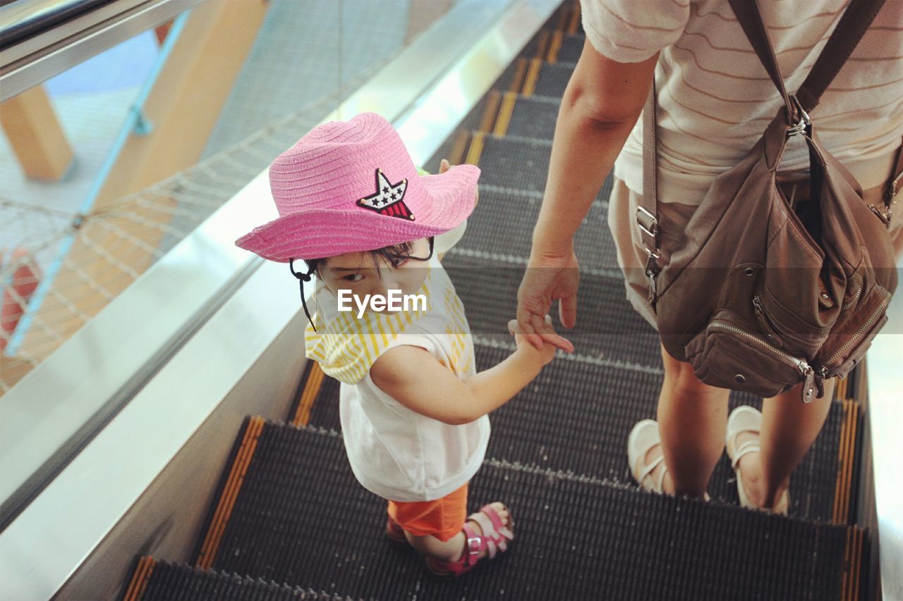 High angle view of child with mother on escalator