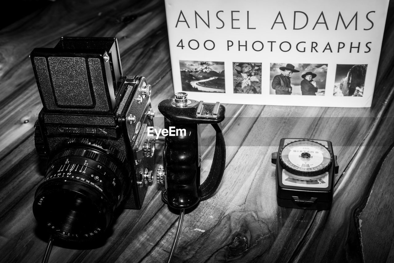 HIGH ANGLE VIEW OF DIGITAL CAMERA ON TABLE AT HOME