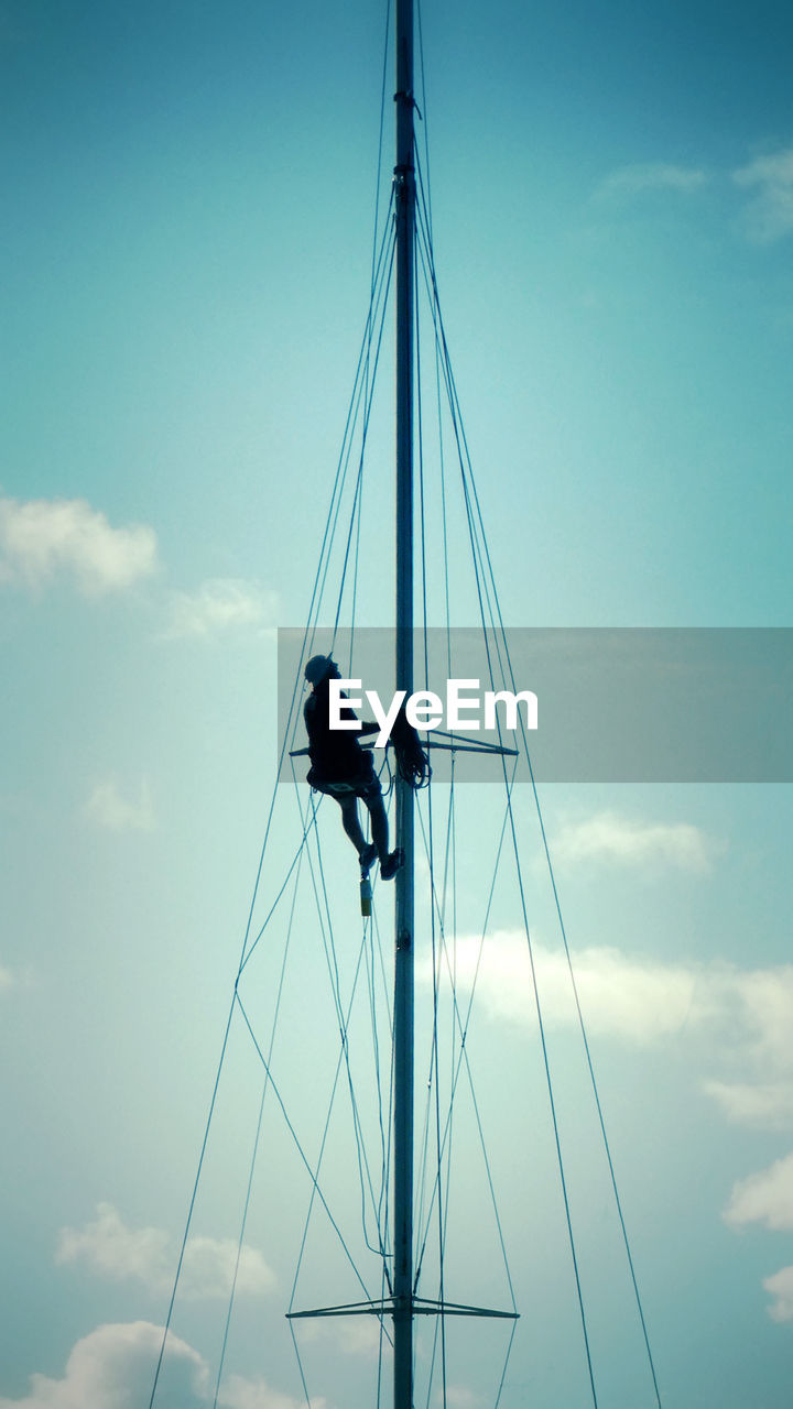 LOW ANGLE VIEW OF SAILBOAT HANGING AGAINST SKY