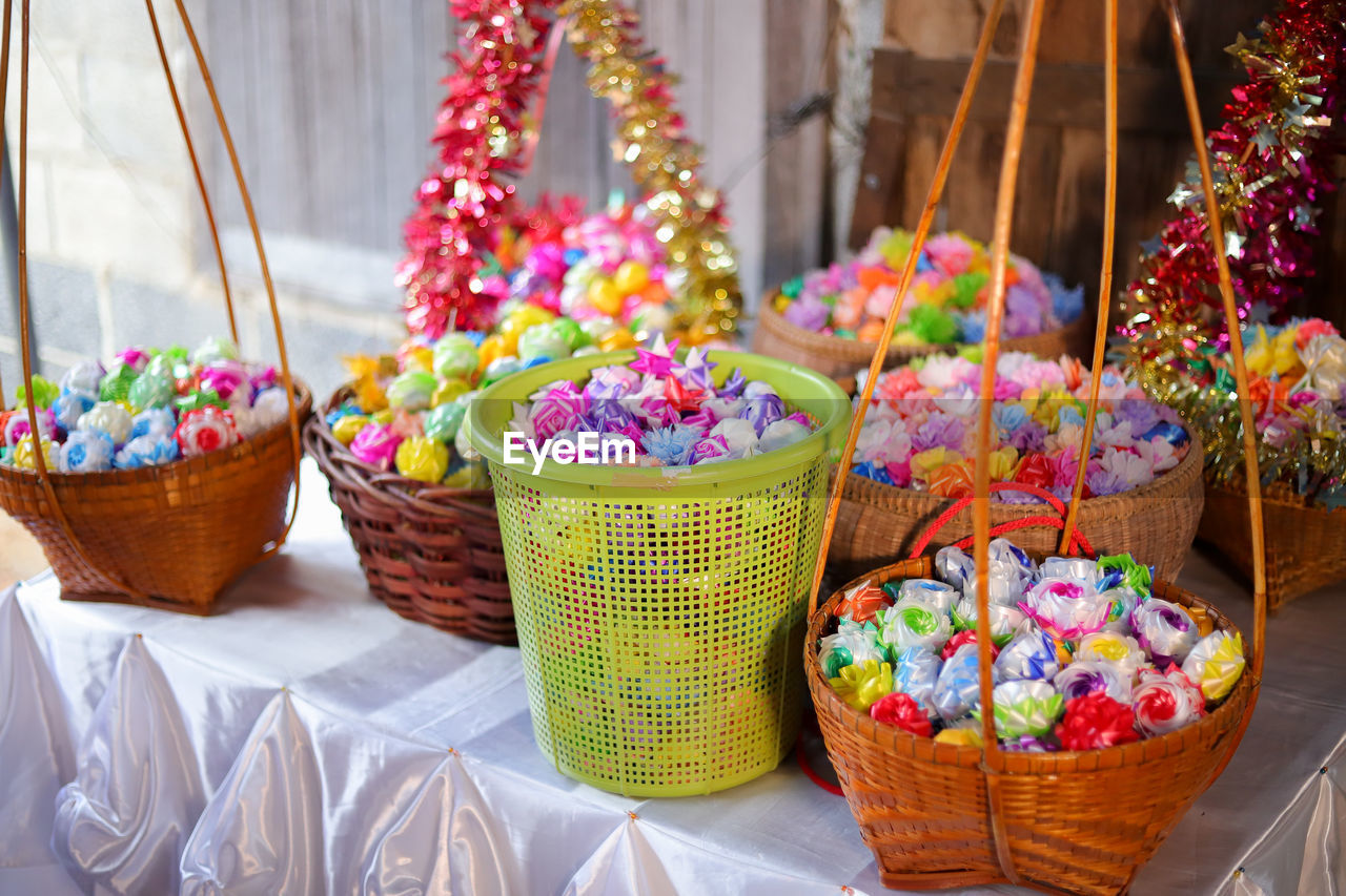 multi colored, food and drink, food, container, no people, dessert, celebration, sweet food, variation, basket, freshness, sweet, decoration, flower, flowering plant, plant, retail, holiday, nature, abundance, large group of objects, outdoors, focus on foreground, day