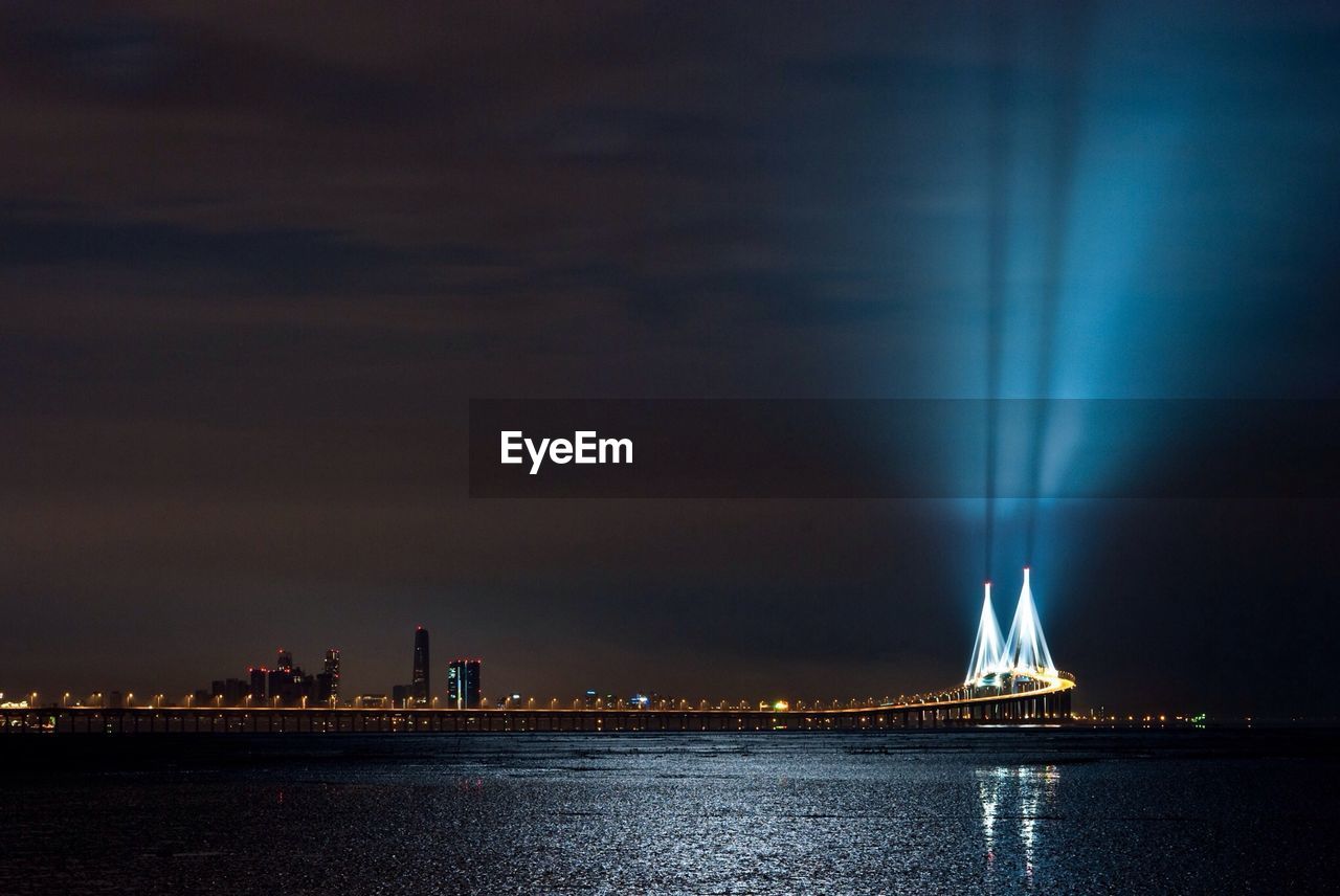 VIEW OF ILLUMINATED CITY AT NIGHT