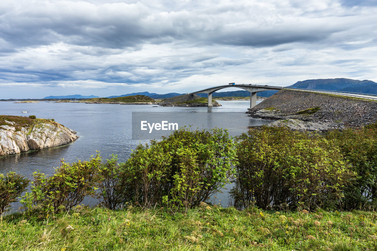 Bus followed by cars at the summit of the most famous bridge of the atlantic road, norway