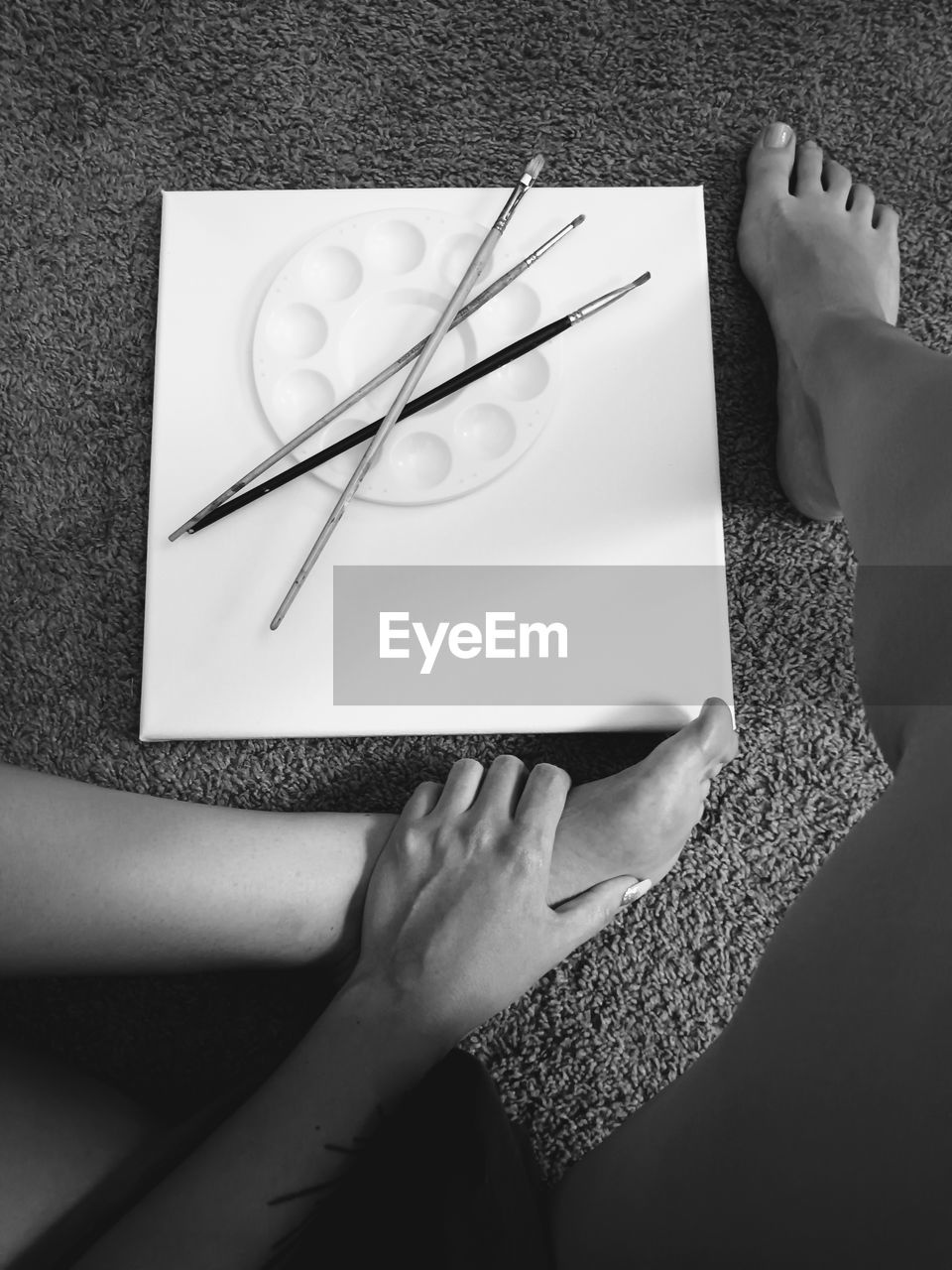 cropped hand of woman writing on book