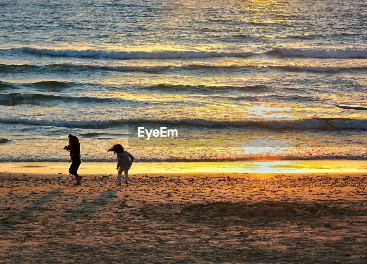 Two children playing on beach