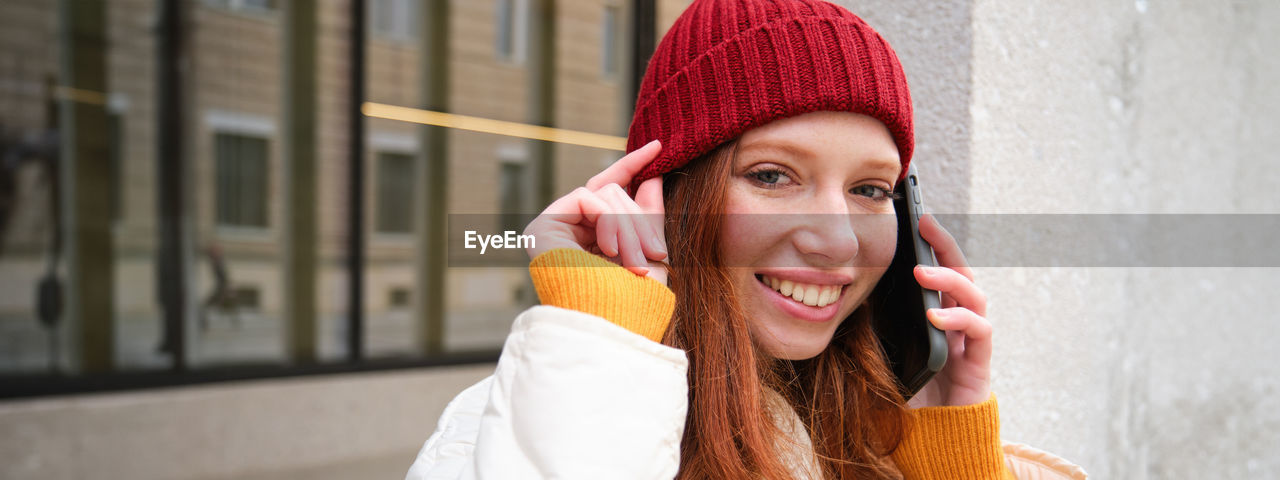 portrait of smiling young woman with eyes closed