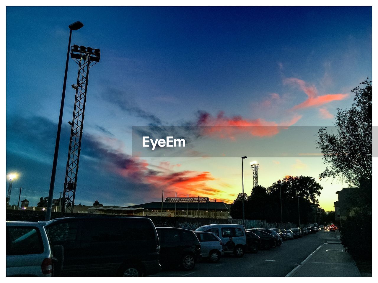 VEHICLES ON ROAD AT SUNSET