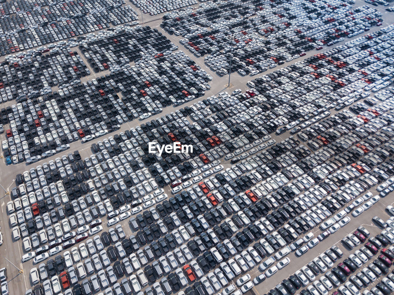 Aerial view of cars parked on parking lot during sunny day