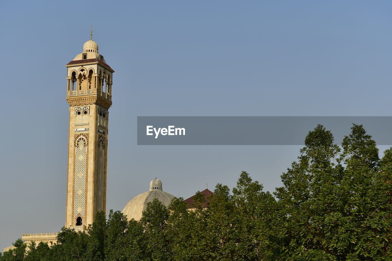 Low angle view of minaret against clear sky