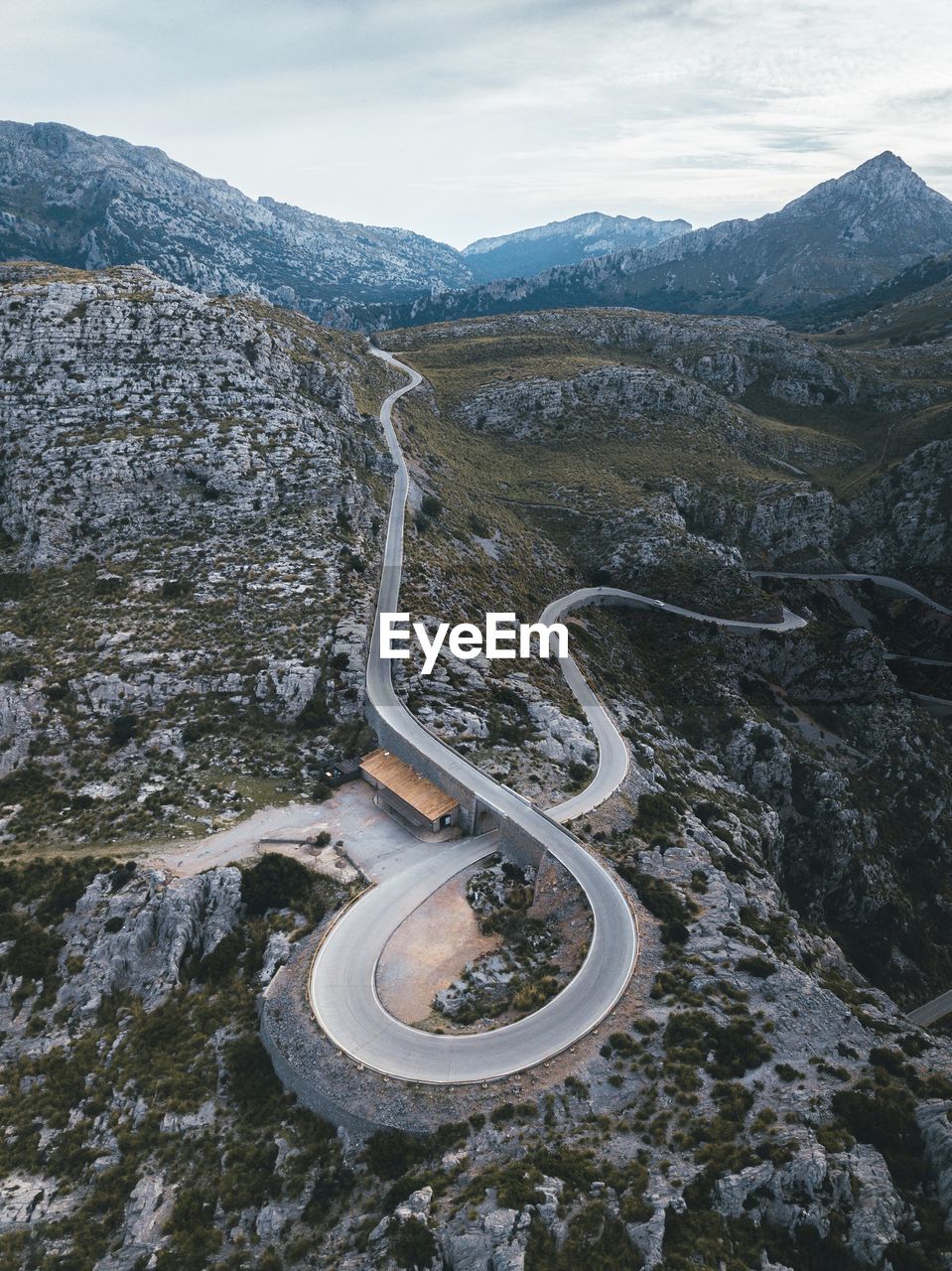 Aerial view of winding road on mountain against sky