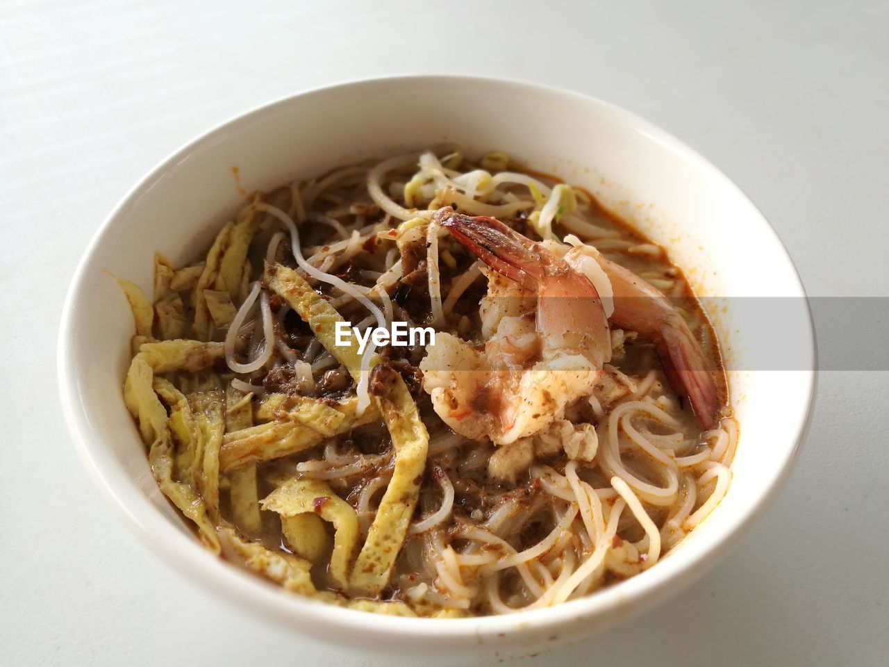 Close-up of noodles in bowl over white background