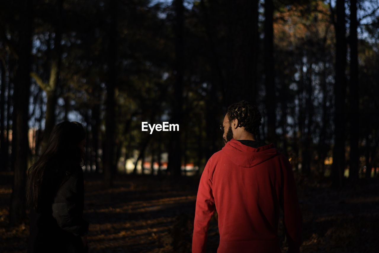 Rear view of man walking in forest