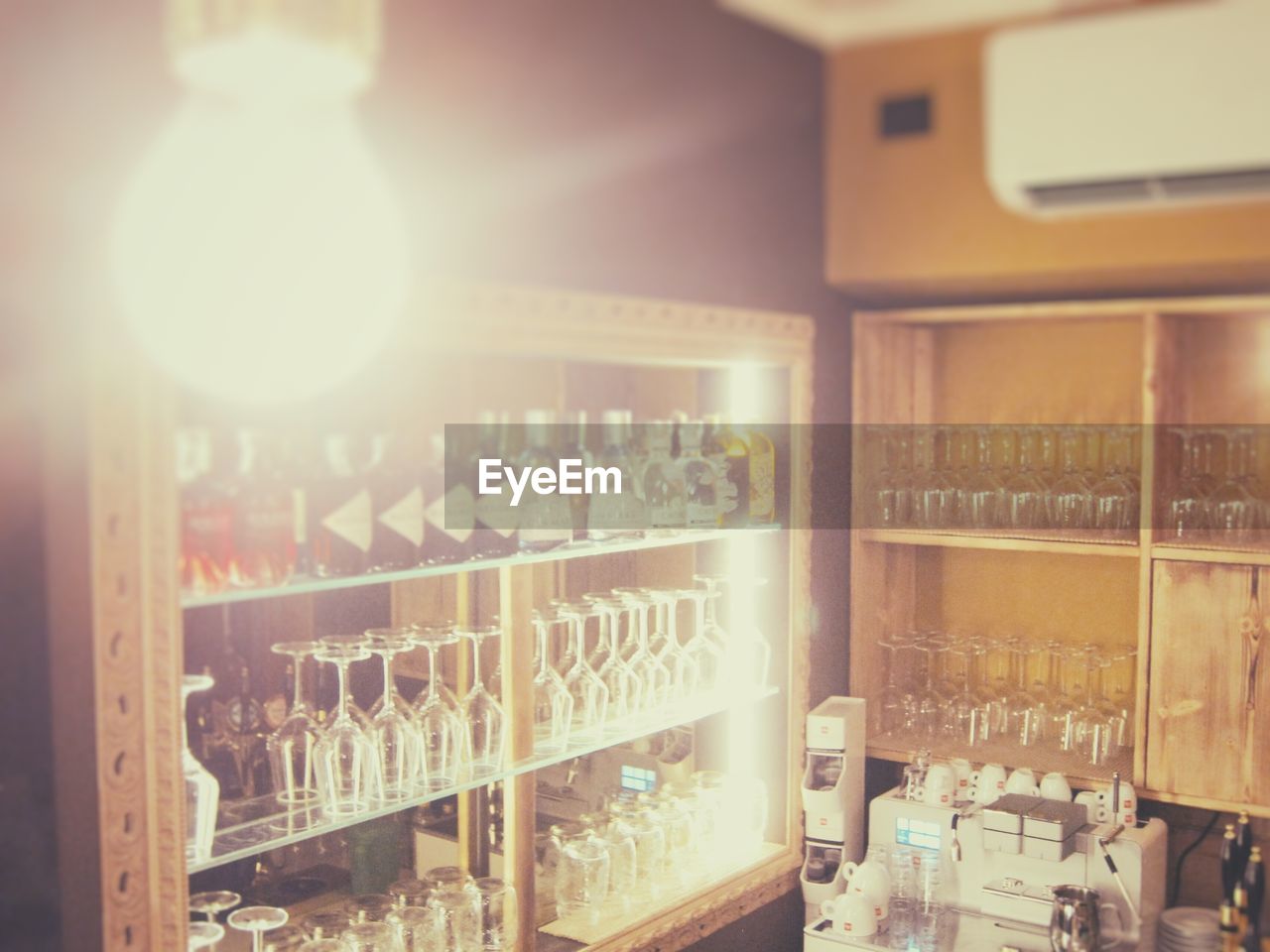 VIEW OF WINE BOTTLES IN SHELF AT BAR