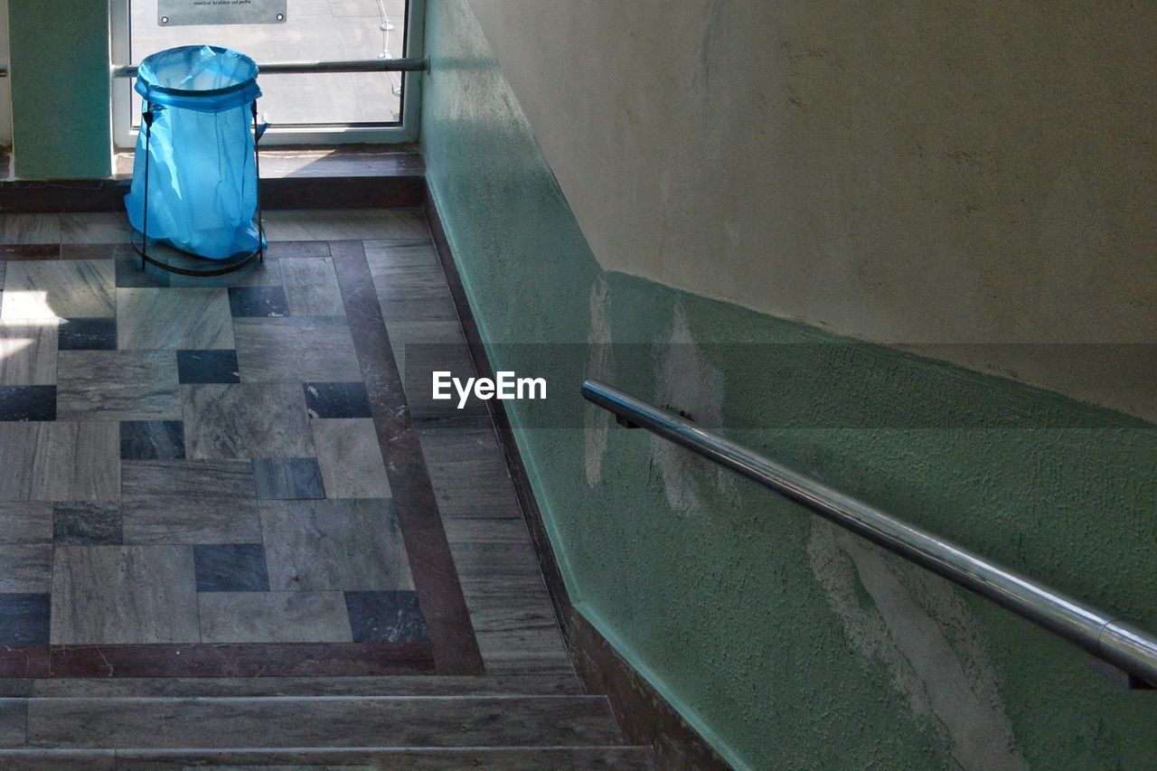 High angle view of garbage bag by window in building