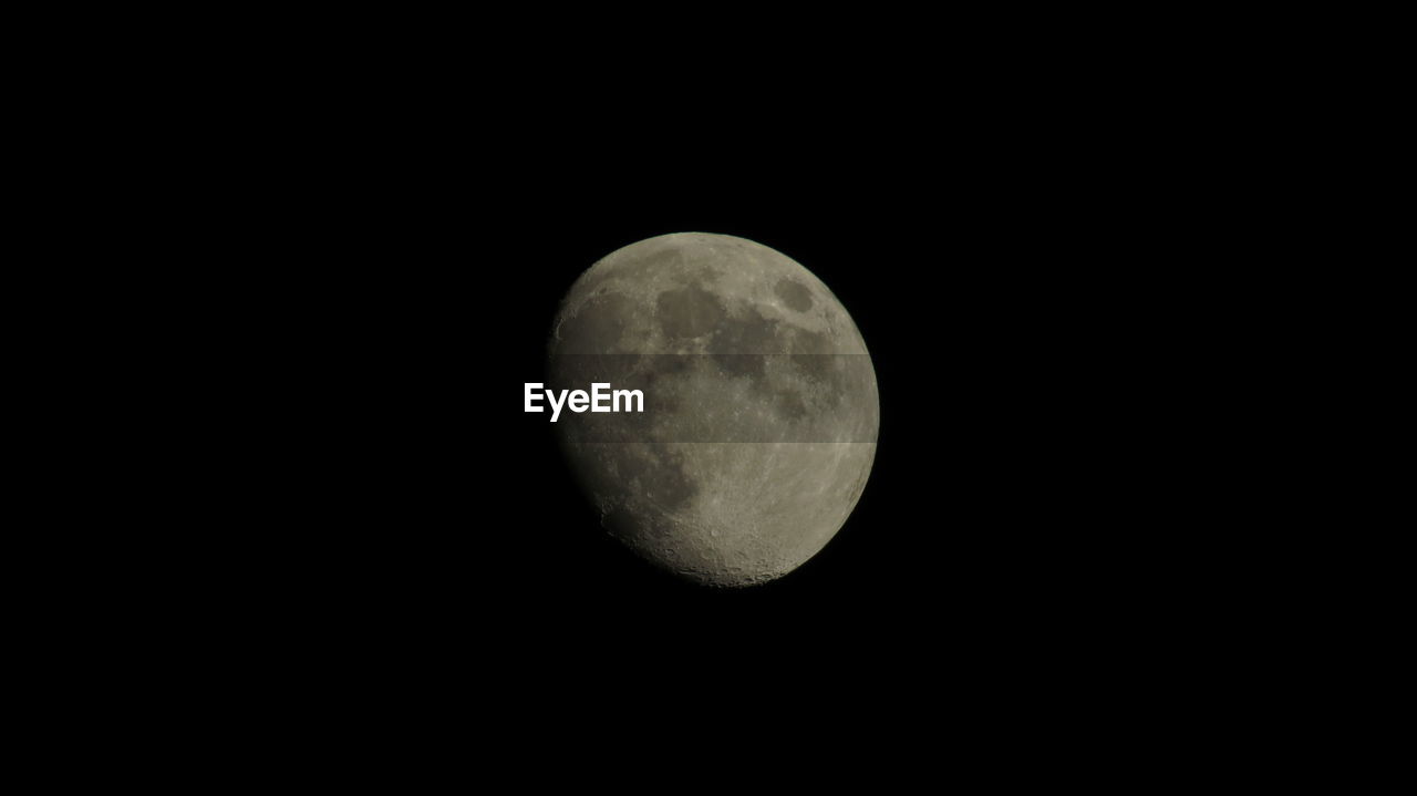 Low angle view of moon against clear sky at night