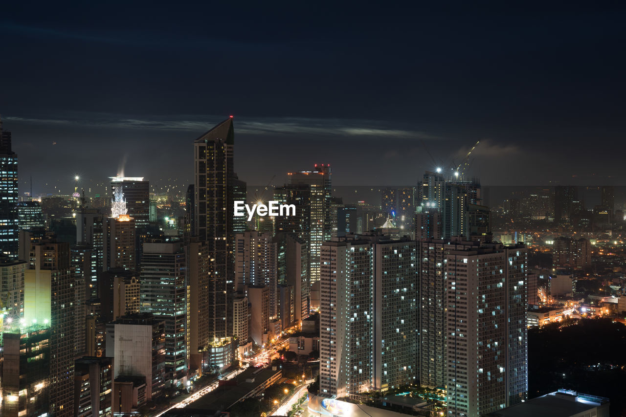 High angle view of illuminated buildings in city at night