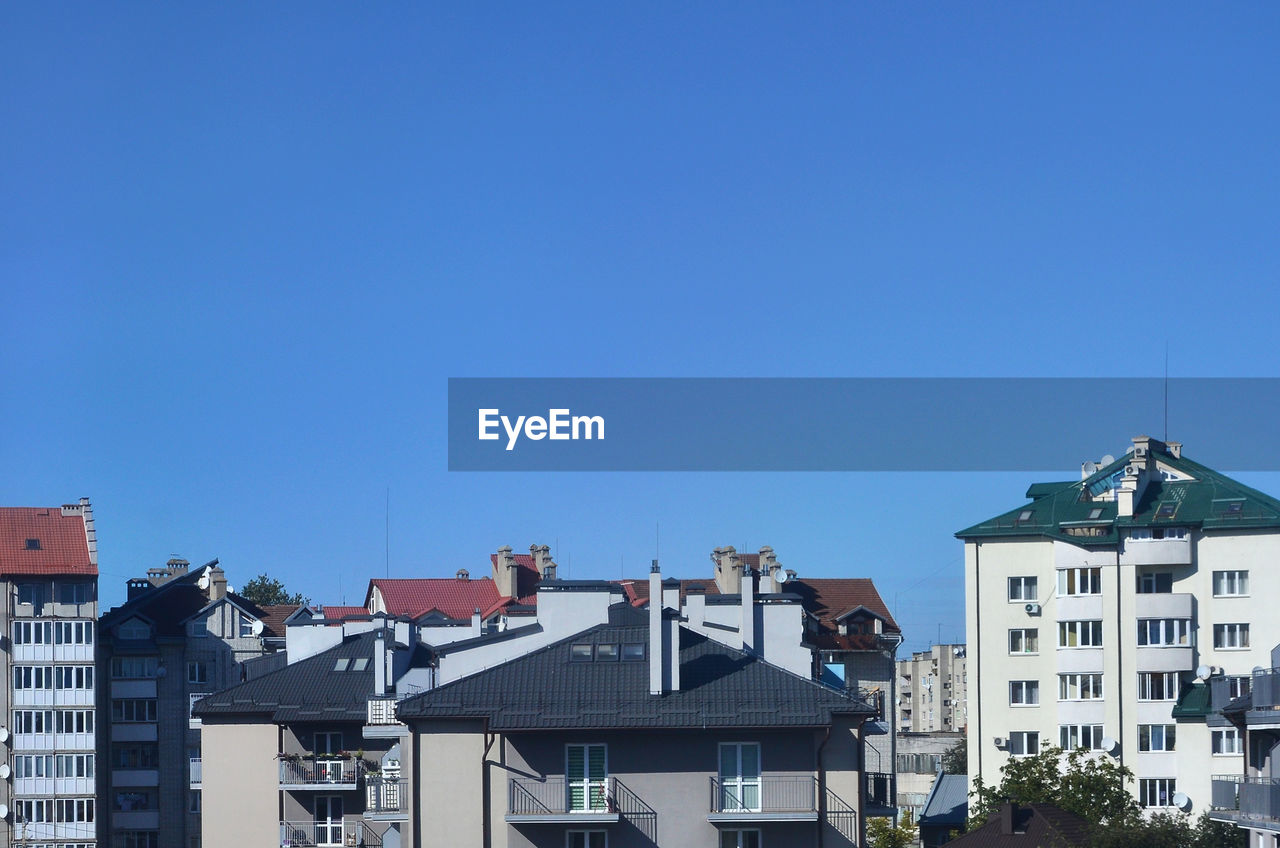 Low angle view of buildings against blue sky