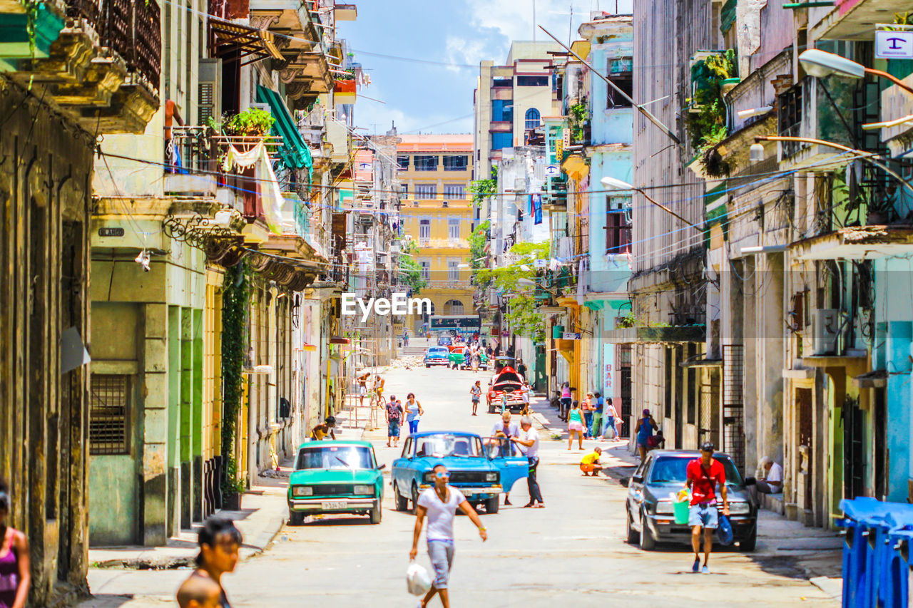 People on street amidst buildings in city