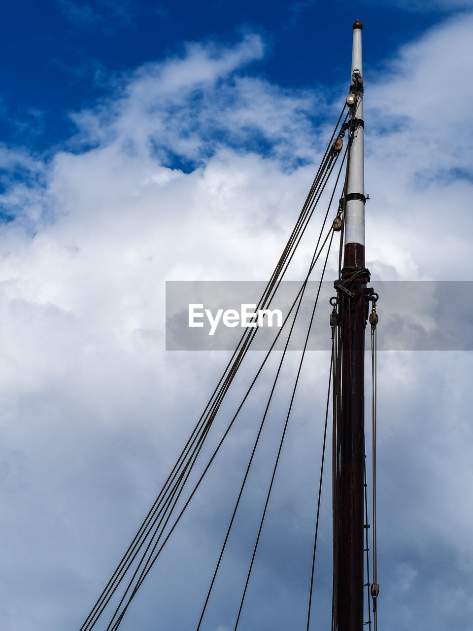 Low angle view of mast against sky